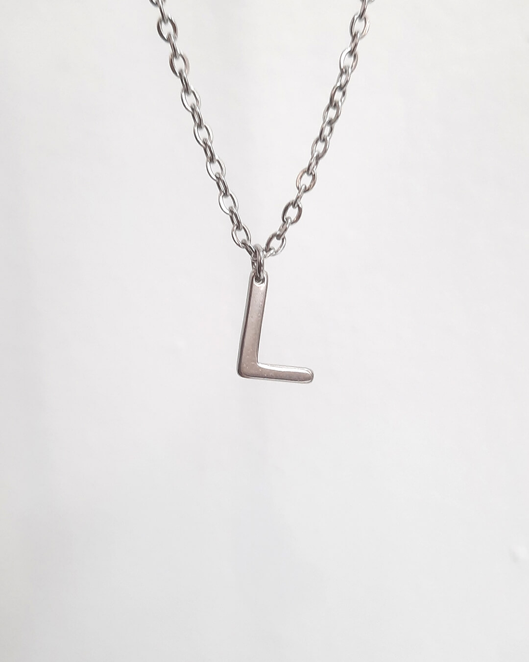 Colgante con forma de letra l de acero inoxidable